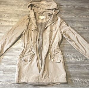 Small Michael Kors Rain Coat. Mint condition and wore once. Zippers, and elegant